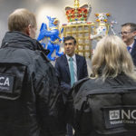 
              Britain's Prime Minister Rishi Sunak meets officers during his visit to the National Crime Agency headquarters in London, Tuesday, Dec. 13, 2022. (Jonathan Buckmaster/Pool Photo via AP)
            