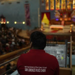 
              Α sound engineer works during a liturgy at the Catholic Church, Our Lady of the Rosary, at the Religious complex, in Doha, Qatar, Friday, Dec. 9, 2022. (AP Photo/Thanassis Stavrakis)
            
