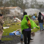 
              Allyson Mitchell walks in the rain after she arrived to help her niece whose home was destroyed from a tornado that tore through the area in Killona, La., about 30 miles west of New Orleans in St. James Parish, Wednesday, Dec. 14, 2022. (AP Photo/Gerald Herbert)
            