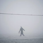 
              A person walks through the snow and fog on Hackney Marshes in London, Sunday Dec. 11, 2022. (Yui Mok/PA Wire/PA via AP)
            