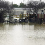 
              A mobile home community in Ruleville, Miss., is flooded from torrential rains that accompanied destructive storms that ripped across the U.S., spawning tornadoes that killed a young boy and his mother in Louisiana, smashed mobile homes and chicken houses in Mississippi and threatened neighboring Southern states with additional severe weather Wednesday, Dec. 14, 2022. (AP Photo/Rogelio V. Solis)
            