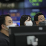 
              Currency traders stand near the screens showing the foreign exchange rates at a foreign exchange dealing room in Seoul, South Korea, Thursday, Dec. 29, 2022. Shares slipped in Asia on Thursday after benchmarks fell more than 1% on Wall Street in the middle of a mostly quiet and holiday-shortened week. (AP Photo/Lee Jin-man)
            