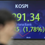 
              A currency trader walks by the screen showing the Korea Composite Stock Price Index (KOSPI) at a foreign exchange dealing room in Seoul, South Korea, Wednesday, Dec. 28, 2022. Shares were mixed in Asia on Wednesday after a post-holiday retreat on Wall Street, as markets count down to the end of a painful year for investors.(AP Photo/Lee Jin-man)
            