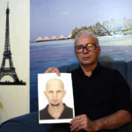 
              FILE - Nelson Faria Marinho shows a picture of his son Nelson Marinho, who lost his life in the 2009 Air France flight 447 accident, during an interview at his home in Rio de Janeiro, Brazil, on Sept. 5, 2019. Families of the 228 people killed aboard a Rio-Paris flight that crashed in 2009 were hoping for justice at last. Instead, they're wracked with anger and disappointment as a long-awaited trial wraps up Thursday, Dec. 8, 2022, with little hope that anyone will be held accountable. (AP Photo/Silvia Izquierdo)
            
