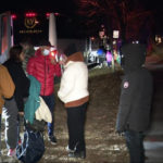 
              This image provided by WJLA shows migrant families as they get on to a bus to transport them from near the Vice President's residence to an area church after they arrived in Washington, Saturday, Dec. 24, 2022. Local organizers in Washington say three buses of recent migrant families arrived from Texas near the home in record-setting cold on Christmas Eve. Texas authorities have not confirmed their involvement. (WJLA via AP)
            