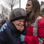 
              A woman cries in front of the building which was destroyed by a Russian attack in Kryvyi Rih, Ukraine, Friday, Dec. 16, 2022. Russian forces launched at least 60 missiles across Ukraine on Friday, officials said, reporting explosions in at least four cities, including Kyiv. At least two people were killed by a strike on a residential building in central Ukraine, where a hunt was on for survivors. (AP Photo/Evgeniy Maloletka)
            