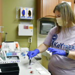 
              Ashley Holliday, senior medical assistant, prepares tests for hepatitis C and HIV in Hazard, Ky., Monday, Dec. 12, 2022. A study underway in the hard-hit corner of the state is exploring a simple way to get more people treated for hepatitis C. (AP Photo/Timothy D. Easley)
            
