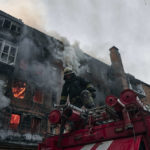 
              Emergency workers put out the fire after Russian shelling hit an apartment building in Bakhmut, Donetsk region, Ukraine, Wednesday, Dec. 7, 2022. (AP Photo/LIBKOS)
            