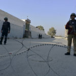 
              Security officials guard a blocked road leading to a counter-terrorism center after security forces starting to clear the compound seized earlier by Pakistani Taliban militants in Bannu, a northern district in the Pakistan's Khyber Pakhtunkhwa province, Tuesday, Dec. 20, 2022. Pakistan's special forces on Tuesday stormed the counter-terrorism center to free several security officials who were taken hostage earlier this week by a group of detained Pakistani Taliban militants, security officials said. (AP Photo/Muhammad Hasib)
            
