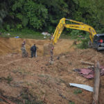
              Rescue teams use a backhoe continue the search for victims caught in a landslide, Saturday, Dec. 17, 2022, in Batang Kali, Malaysia. A landslide Friday, Dec. 16, 2022, at a tourist campground in Malaysia left more than a dozen of people dead and authorities said a dozen of others were feared buried at the site on an organic farm outside the capital of Kuala Lumpur. (AP Photo Vincent Thian)
            