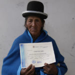 
              Anacleta Mamani Quispe, 71, poses for a photo after receiving her certificate during an adult literacy graduation ceremony in Pucarani, Bolivia, Sunday, Dec. 4, 2022. Mamami is among more than 20,000 senior citizens, mainly women from low-income rural communities, who have learned to read and write this year as part of “Bolivia Reads,” a government-sponsored literacy program. (AP Photo/Juan Karita)
            