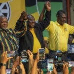 
              South African President Cyril Ramaphosa, center, celebrates after being re-elected African National Congress president at the ANC national conference in Johannesburg, South Africa, Monday, Dec. 19, 2022. The national conference is held every five years and is the ANC's highest decision-making body. (AP Photo/Jerome Delay)
            
