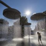 
              FILE - A boy cools off in a public fountain in Vilnius, Lithuania, June 26, 2022. This past year has seen a horrific flood that submerged one-third of Pakistan, one of the three costliest U.S. hurricanes on record, devastating droughts in Europe and China, a drought-triggered famine in Africa and deadly heat waves all over. (AP Photo/Mindaugas Kulbis, File)
            