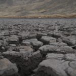 
              Dry earth crusts on the bed of the Cconchaccota lagoon in the Apurimac region of Peru, Friday, Nov. 25, 2022. For climate experts the lagoon could have dried up because it was less than a meter deep, depended exclusively on rainwater and was under strong solar radiation. (AP Photo/Guadalupe Pardo)
            