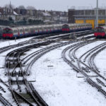 
              Snow covers the tracks as tube trains are parked in London, Monday, Dec. 12, 2022. Snow and ice have swept across parts of the UK, with cold wintry conditions set to continue for days. (AP Photo/Kirsty Wigglesworth)
            