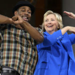 
              FILE - Democratic presidential candidate Hillary Rodham Clinton, right, practices her dance moves with DJ Stephen "tWitch" Boss during a break in the taping of "The Ellen DeGeneres Show" in New York on Sept. 8, 2015. Boss, a longtime DJ and co-executive producer on the talk show “The Ellen DeGeneres Show” and former contestant on the dance competition show, “So You Can Think You Can Dance”  has died at the age of 40. (AP Photo/Mary Altaffer, File)
            