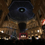 
              People gather inside the Vittorio Emanuele II gallery to watch the premiere of La Scala opera house on a screen in Milan, Italy, Wednesday, Dec. 7, 2022. Italy's most famous opera house, Teatro alla Scala, opens its new season 2022/2023 Wednesday with the Russian opera "Boris Godunov," against the backdrop of Russia's invasion of Ukraine and Ukrainian protests that the cultural event is a propaganda win for the Kremlin. (AP Photo/Antonio Calanni)
            