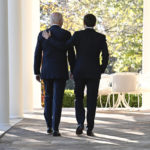 
              President Joe Biden and French President Emmanuel Macron walk along the Colonnade of the White House in Washington, Thursday, Dec. 1, 2022. (Jim Watson/Pool Photo via AP)
            