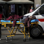 
              An elderly woman on a stretcher is wheeled into the fever clinic at a hospital in Beijing, Sunday, Dec. 11, 2022. Facing a surge in COVID-19 cases, China is setting up more intensive care facilities and trying to strengthen hospitals as Beijing rolls back anti-virus controls that confined millions of people to their homes, crushed economic growth and set off protests. (AP Photo/Andy Wong)
            