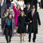 
              Lorie Smith, a Christian graphic artist and website designer in Colorado, center in pink, walks out of the Supreme Court in Washington, Monday, Dec. 5, 2022, after her case was heard before the Supreme Court. The Supreme Court is hearing the case of Smith who objects to designing wedding websites for gay couples, that's the latest clash of religion and gay rights to land at the highest court. (AP Photo/Andrew Harnik)
            
