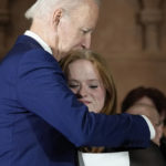 
              President Joe Biden hugs Sandy Hook survivor Jackie Hegarty, who introduced him, during an event in Washington, Wednesday, Dec. 7, 2022, with survivors and families impacted by gun violence for the 10th Annual National Vigil for All Victims of Gun Violence. (AP Photo/Susan Walsh)
            