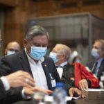 
              Bolivian Foreign Minister, Rogelio Mayta, second left, prepares for the verdict reading at the World Court in The Hague, Netherlands, Thursday, Dec. 1, 2022, where the UN's top court rules on a dispute about a river that crosses Chile's and Bolivia's border, in a case seen as important jurisprudence at a time when fresh water is becoming an increasingly coveted world resource. (AP Photo/Peter Dejong)
            