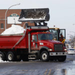 
              A front end loader dump snow into a dump truck as crews clear large amounts of snow, Wednesday, Dec. 28, 2022, in Buffalo N.Y., days after a winter storm passed through. (AP Photo/Jeffrey T. Barnes)
            