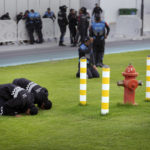 
              Police pray as they wait ahead of the World Cup quarterfinal soccer match between Morocco and Portugal, at Al Thumama Stadium in Doha, Qatar, Saturday, Dec. 10, 2022. (AP Photo/Jorge Saenz)
            