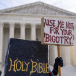 
              A person dressed as a bible holds a sign that reads "Use Me Not For Your Bigotry" outside the Supreme Court in Washington, Monday, Dec. 5, 2022. The Supreme Court is hearing the case of a Christian graphic artist who objects to designing wedding websites for gay couples, that's the latest clash of religion and gay rights to land at the highest court. (AP Photo/Andrew Harnik)
            