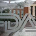 
              FILE - This Aug. 2, 2018, file photo shows the U.S. Food and Drug Administration building behind FDA logos at a bus stop on the agency's campus in Silver Spring, Md.  (AP Photo/Jacquelyn Martin, File)
            