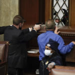 
              FILE - Police with guns drawn watch as rioters try to break into the House Chamber at the U.S. Capitol on Wednesday, Jan. 6, 2021, in Washington. Top House and Senate leaders will present law enforcement officers who defended the U.S. Capitol on Jan. 6, 2021, with Congressional Gold Medals on Wednesday, Dec. 7, 2022, awarding them Congress's highest honor nearly two years after they fought with former President Donald Trump’s supporters in a brutal and bloody attack. (AP Photo/J. Scott Applewhite, File)
            