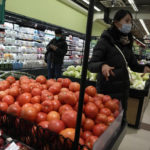 
              Shoppers buy fresh produces at a supermarket in Beijing, Wednesday, Dec. 28, 2022. China is on a bumpy road back to normal life as schools, shopping malls and restaurants fill up again following the abrupt end of some of the world's most severe restrictions even as hospitals are swamped with feverish, wheezing COVID-19 patients. (AP Photo/Ng Han Guan)
            