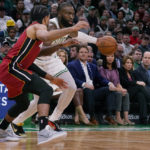 
              Britain's Prince William and Kate, Princess of Wales, at right, watch as Boston Celtics guard Jaylen Brown drives to the basket against Miami Heat guard Gabe Vincent (2) during the first half of an NBA basketball game, Wednesday, Nov. 30, 2022, in Boston. (AP Photo/Charles Krupa)
            