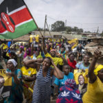 
              Supporters of William Ruto hold campaign posters of him and wave a national flag as they celebrate and march along a street in the Kibera neighborhood of Nairobi, Kenya Monday, Sept. 5, 2022. Elections, coups, disease outbreaks and extreme weather are some of the main events that occurred across Africa in 2022.  Experts say the climate crisis is hitting Africa “first and hardest.” Kevin Mugenya, a senior food security advisor for Mercy Corps said the continent of 54 countries and 1.3 billion people is facing “a catastrophic global food crisis” that “will worsen if actors do not act quickly.”  (AP Photo/Ben Curtis)
            