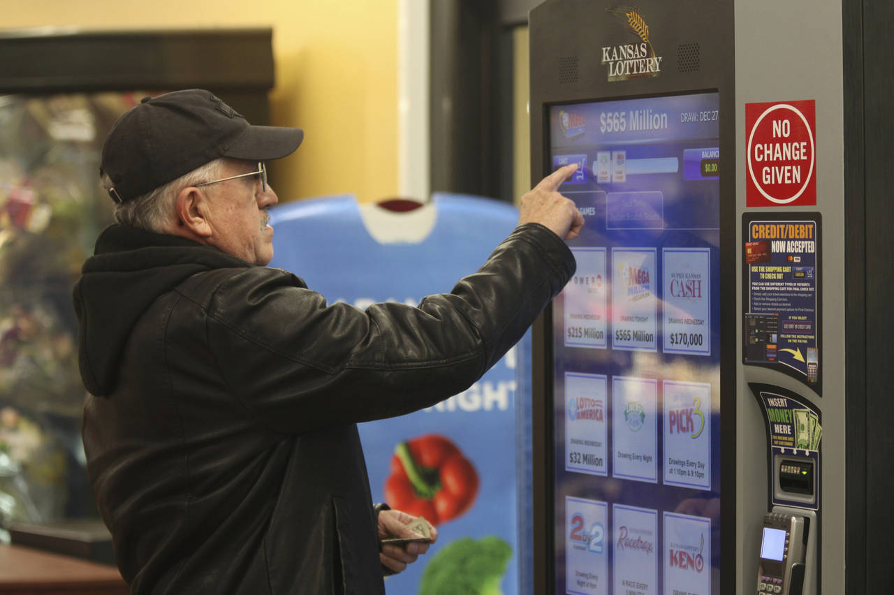 David Peralta, a 67-year-old retired technical college instructor, buys a Mega Millions ticket at a...
