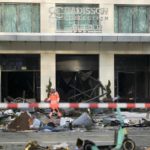 
              A firefighter walks through debris in front of a hotel where an huge aquarium has burst in Berlin, Germany, Friday, Dec. 16, 2022. German police say a huge fish tank in the center of Berlin has burst, causing a wave of devastation in and around the Sea Life tourist attraction. (AP Photo/Markus Schreiber)
            