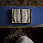 
              FILE - A student reads the Quran at a madrassa in Kabul, Afghanistan, Tuesday, Sept. 28, 2021. The American concept of adoption doesn't exist in Afghanistan. Under Islamic law, a child's bloodline cannot be severed and their heritage is sacred. Instead of adoption, a guardianship system called kafala allows Muslims to take in orphans and raise them as family, without relinquishing the child's name or bloodline. (AP Photo/Felipe Dana, File)
            