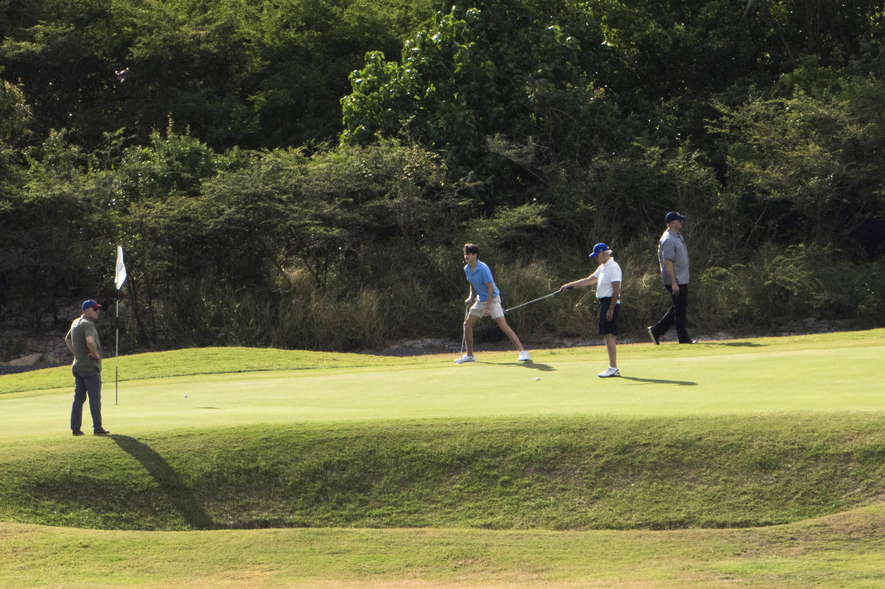 President Joe Biden plays golf with grandson Hunter Biden, second from left, at The Buccaneer in Ch...