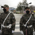 South Korean army soldiers stand guard before K-pop band BTS's member Jin enters the army to serve near an army training center in Yeoncheon, South Korea, Tuesday, Dec. 13, 2022. Jin, the oldest member of K-pop supergroup BTS, was set to enter a frontline South Korean boot camp Tuesday to start his 18 months of mandatory military service, as fans gathered near the base to say goodbye to their star. (AP Photo/Ahn Young-joon)