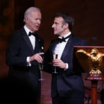 
              President Joe Biden and French President Emmanuel Macron talk after a toast during a State Dinner on the South Lawn of the White House in Washington, Thursday, Dec. 1, 2022. (AP Photo/Andrew Harnik)
            