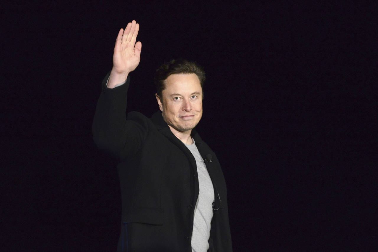 FILE - SpaceX's Elon Musk waves while providing an update on Starship, on Feb. 10, 2022, near Brown...