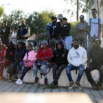 
              Haitian migrants listen to immigration attorneys giving updates on their current asylum status, Tuesday, Dec. 20, 2022, in Tijuana, Mexico. The U.S. government made its plea in a filing a day after Chief Justice John Roberts issued a temporary order to keep the pandemic-era limits on migrants in place. (AP Photo/Marcio Jose Sanchez)
            