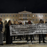
              Protesters hold a banner which reads in Greek "they shot them because they were Roma" as they protest the shooting in the head of a 16-year-old youth, outside the Greek parliament , in central Athens, Monday Dec 5, 2022. A police officer has been arrested in northern Greece after a 16-year-old boy was shot in the head and seriously injured during a car chase after he allegedly failed to pay the bill at a gas station(AP Photo/Michael Varaklas)
            