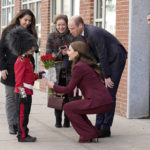 
              Henry Dynov-Teixeira, 8, of Somerville, presents flowers to Britain's Prince William and Kate, Princess of Wales, as his parents Melissa, left, and Irene, look on following a visit to Greentown Labs, Thursday, Dec. 1, 2022, in Somerville, Mass. (AP Photo/Mary Schwalm)
            