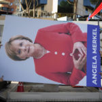 
              Municipal workers prepare to put up a portrait of former German Chancellor Angela Merkel as they decorate the Martyrs of the Nation boulevard with images of personalities who had a contribution to the advancement of the European Union, in Tirana, Albania, Monday, Dec. 5, 2022. As the war in Ukraine has put the bloc's enlargement back at the top of the agenda, Albania hosts in Tirana leaders of the EU and the Western Balkans countries for a one-day summit aimed at reinvigorating the bloc's enlargement process. (AP Photo/Andreea Alexandru)
            