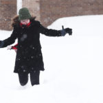 
              Emily Quartley tries to avoid falling while running in a large amount of snow in a Walgreens parking lot in Buffalo, N.Y., on Monday, Dec. 26, 2022. (Joseph Cooke/The Buffalo News via AP)
            