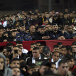 
              Hamas police officers and residents watch a live broadcast of the World Cup semifinal soccer match between Morocco and France played in Qatar, at the municipality stadium in Rafah refugee camp, Southern Gaza Strip, Wednesday, Dec. 14, 2022. (AP Photo/Adel Hana)
            