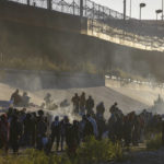 
              Smoke rises from small fires keeping migrants warm as they wait to cross the Mexico-U.S. border from Ciudad Juarez, Mexico, Monday, Dec. 12, 2022. According to the Ciudad Juarez Human Rights Office, hundreds of mostly Central American migrants arrived in buses and crossed the border to seek asylum in the U.S., after spending the night in shelters. (AP Photo/Christian Chavez)
            