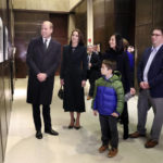 
              Boston Mayor Michelle Wu, right, husband Conor Perwarski, right, and sons Blaise, holds her hand, and Cass, front, show photographs of the Queen Elizabeth II's visit in 1976, during the visit of Britain's Prince William and Kate, Princess of Wales, to Boston City Hall on Wednesday, Nov. 30, 2022, in Boston. The Prince and Princess of Wales are making their first overseas trip since the death of Queen Elizabeth II in September.  (Nancy Lane/The Boston Herald via AP, Pool)
            