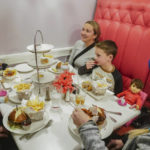 
              Elizabeth Hulanick, far right, sit with her sister Sara Gaskill, second from left, and her children Abbey, 9, far left, and Jack, 7, second from right, for a meal at the American Girl Cafe, Friday, Dec. 2, 2022, in New York. Hulanick, a 37-year-old Piscataway, New Jersey resident, said she keeps her American Girl doll called Samantha in her China cabinet as a reminder to always be patient. (AP Photo/Bebeto Matthews)
            